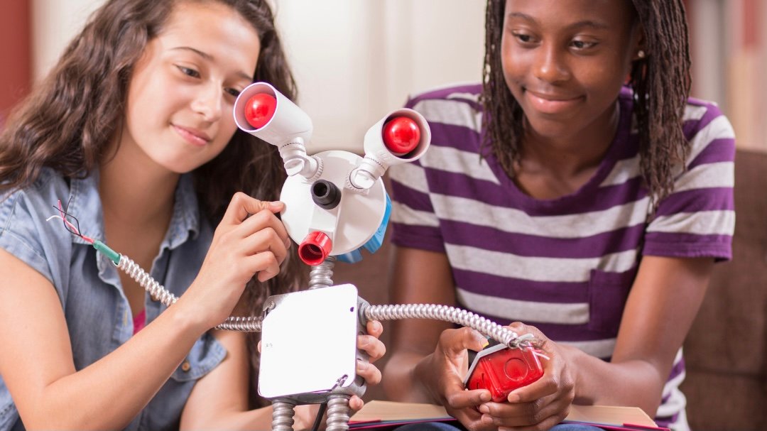 2 young girls working on a science project