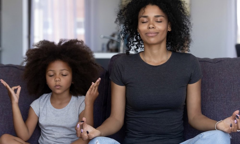mother and daughter in meditation pose